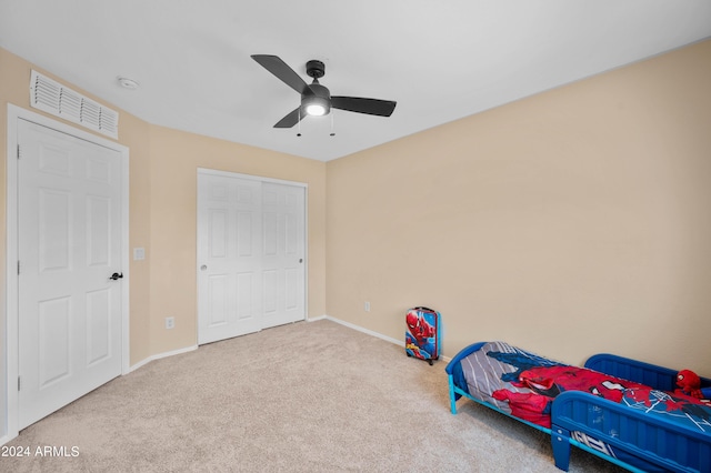 bedroom with carpet flooring, a closet, and ceiling fan