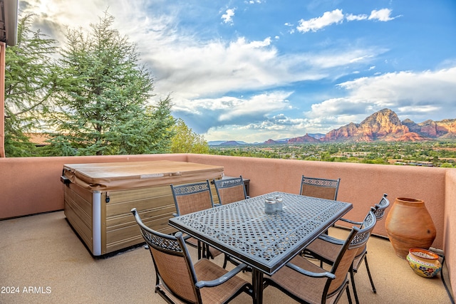 view of patio featuring a mountain view and a hot tub