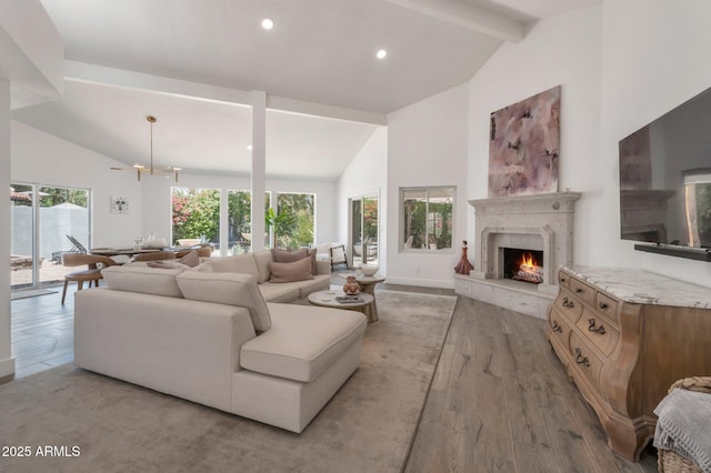 8719 E San Marino Dr, Scottsdale, AZ 85258 - living area with high vaulted ceiling, beam ceiling, light wood finished floors, and a fireplace