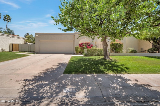 8719 E San Marino Dr, Scottsdale, AZ 85258 - adobe home featuring an attached garage, driveway, a front yard, and stucco siding