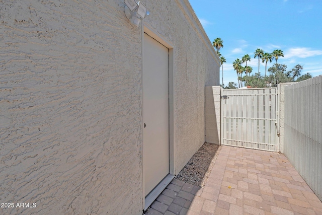 8719 E San Marino Dr, Scottsdale, AZ 85258 - view of property exterior with stucco siding, a gate, and fence
