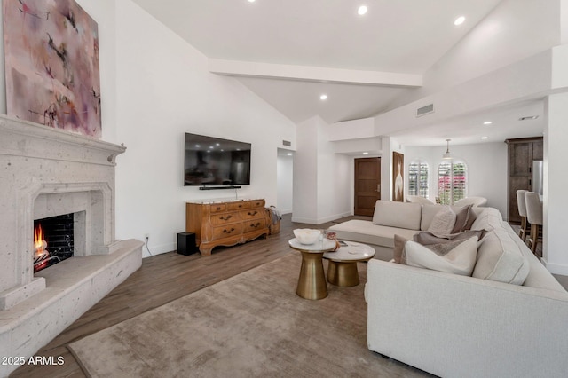 8719 E San Marino Dr, Scottsdale, AZ 85258 - living room featuring baseboards, beam ceiling, wood finished floors, and recessed lighting