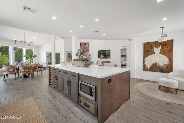 8719 E San Marino Dr, Scottsdale, AZ 85258 - kitchen featuring open floor plan, light wood-style floors, and recessed lighting