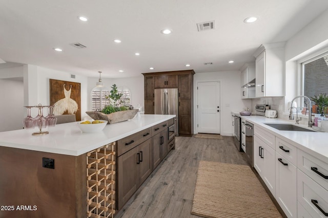 8719 E San Marino Dr, Scottsdale, AZ 85258 - kitchen with stainless steel appliances, a sink, visible vents, recessed lighting, and a kitchen island