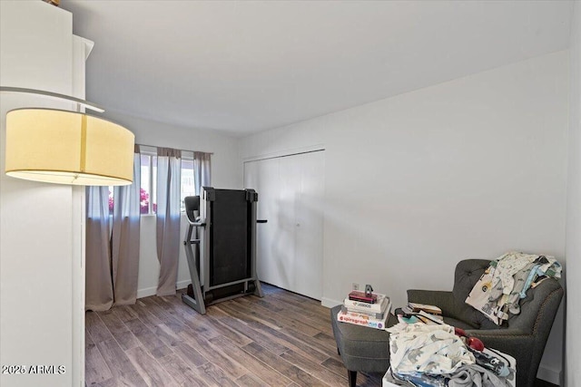 sitting room with wood finished floors and baseboards