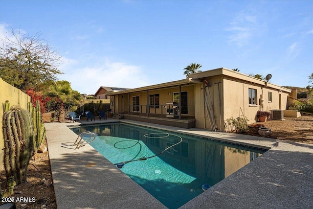 view of pool featuring a fenced backyard, a fenced in pool, cooling unit, and a patio