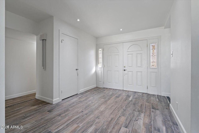 unfurnished bedroom featuring recessed lighting, wood finished floors, a closet, and baseboards