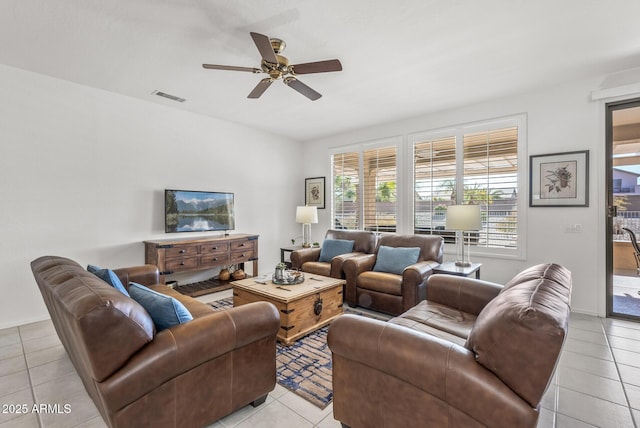 tiled living room featuring ceiling fan