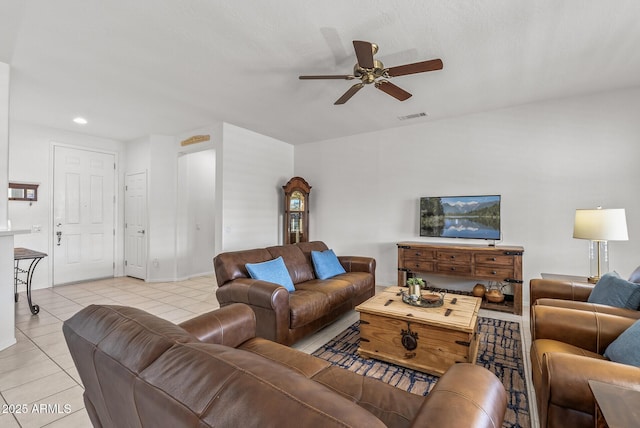 tiled living room with ceiling fan