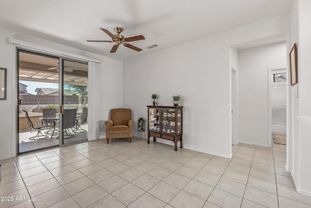 living area featuring ceiling fan and light tile patterned floors