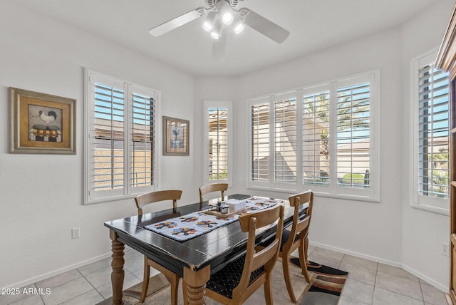 dining space featuring ceiling fan, a healthy amount of sunlight, and light tile patterned flooring