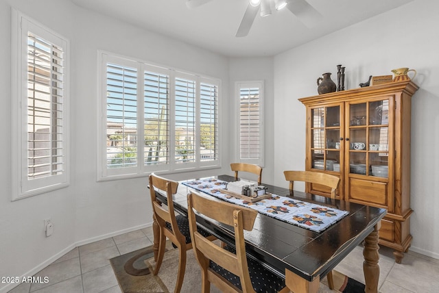 tiled dining area featuring ceiling fan