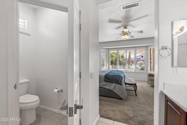 bathroom featuring toilet, ceiling fan, tile patterned flooring, and vanity