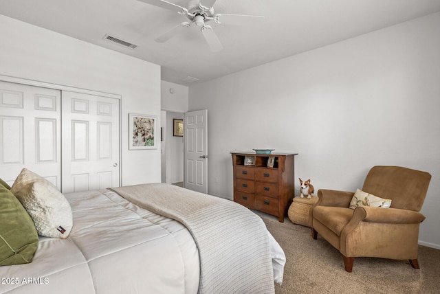 carpeted bedroom featuring ceiling fan and a closet