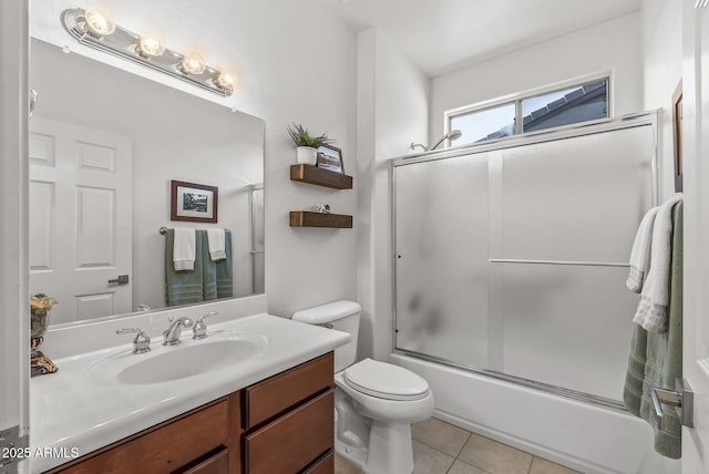 full bathroom with toilet, tile patterned flooring, enclosed tub / shower combo, and vanity