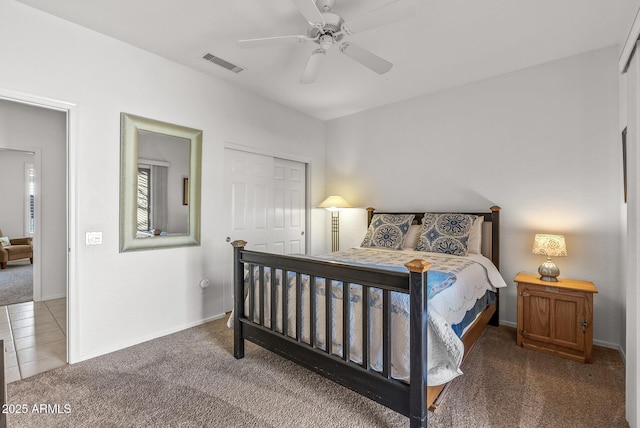 carpeted bedroom with ceiling fan and a closet