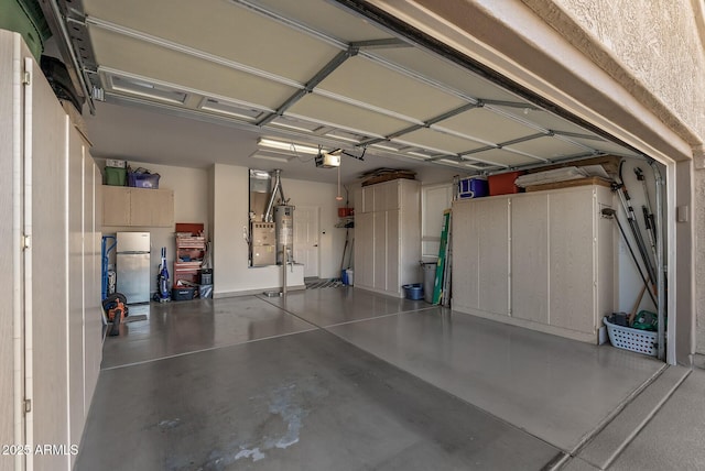 garage featuring fridge, gas water heater, and a garage door opener