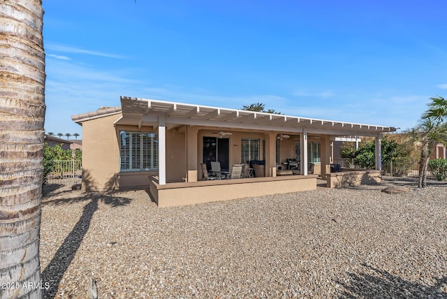 back of house with ceiling fan and a patio area