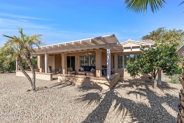 rear view of property with a pergola, a patio area, an outdoor living space, and ceiling fan