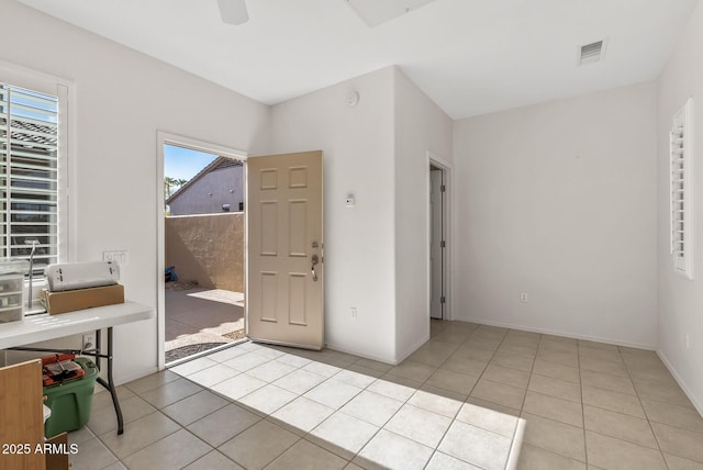 entryway with ceiling fan and light tile patterned floors