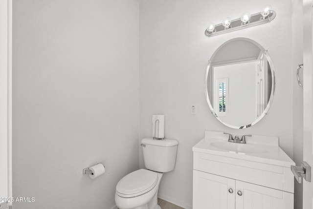 bathroom with toilet and vanity