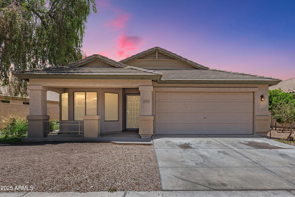 16783 W Taylor St, Goodyear, AZ 85338 - single story home featuring driveway, an attached garage, stucco siding, and a tiled roof