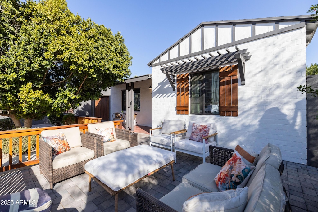 deck with an outdoor living space and a patio area