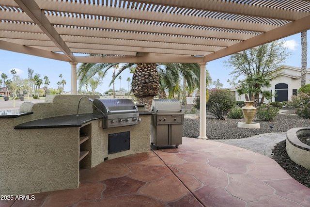 view of patio featuring area for grilling, an outdoor kitchen, and a pergola