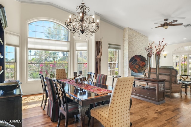 dining room featuring light wood-style flooring, a healthy amount of sunlight, and ornamental molding