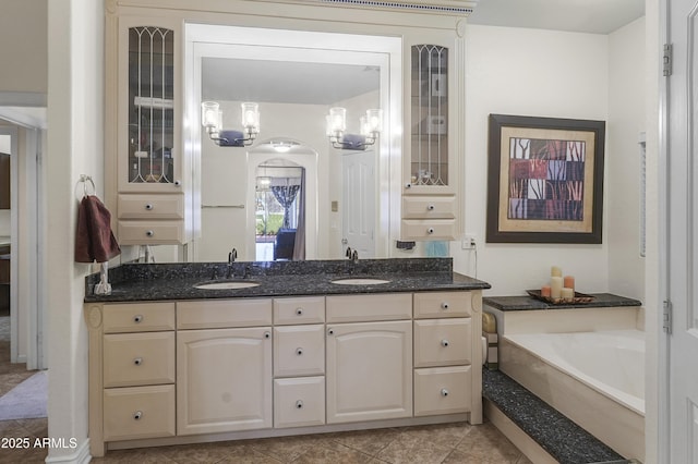 full bathroom with a sink, a garden tub, double vanity, and tile patterned flooring