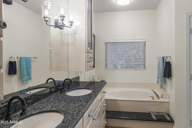 bathroom featuring a garden tub, double vanity, and a sink