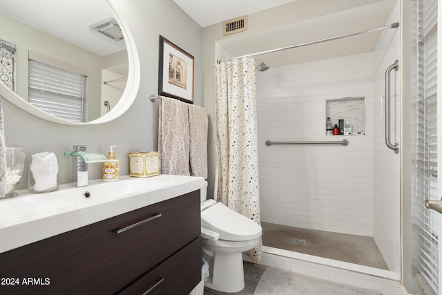 full bathroom featuring visible vents, toilet, a shower stall, vanity, and tile patterned flooring