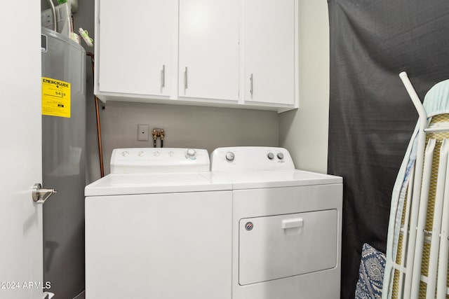 laundry area featuring washer and dryer and cabinets