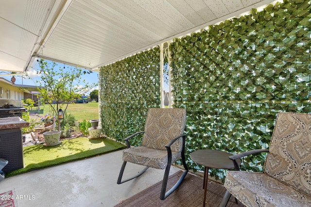 view of patio with area for grilling and covered porch