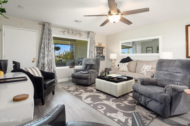 living room with visible vents, ceiling fan, and wood finished floors