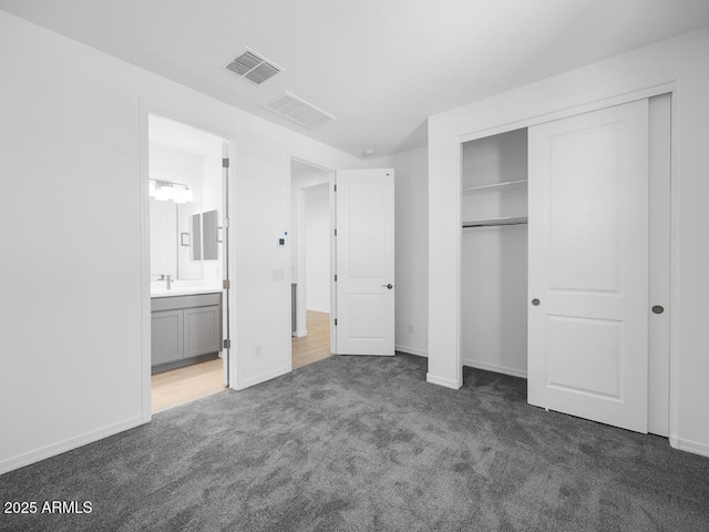 17815 W Denton Ave, Litchfield Park, AZ 85340 - unfurnished bedroom with carpet, a closet, connected bathroom, baseboards, and a sink