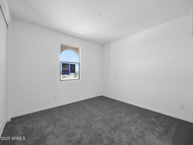 17815 W Denton Ave, Litchfield Park, AZ 85340 - empty room featuring dark colored carpet and baseboards