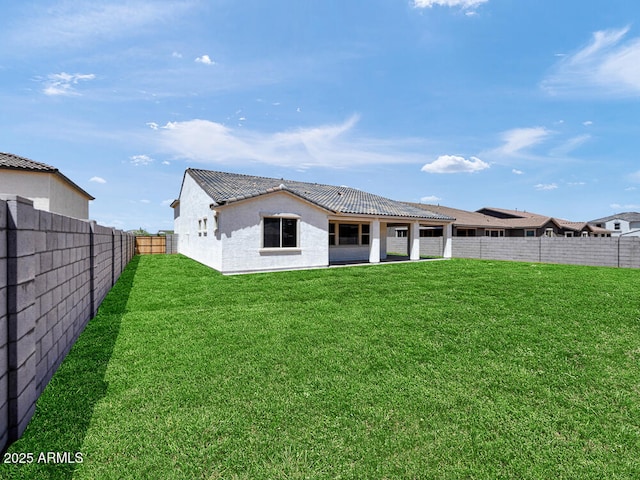 17815 W Denton Ave, Litchfield Park, AZ 85340 - back of house with a tile roof, stucco siding, and a patio