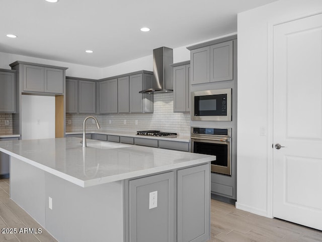 17815 W Denton Ave, Litchfield Park, AZ 85340 - kitchen featuring stainless steel appliances, wall chimney exhaust hood, gray cabinetry, a sink, and recessed lighting