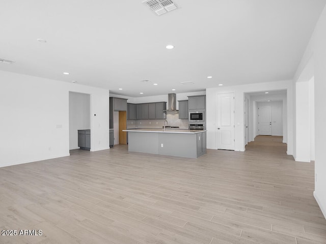 17815 W Denton Ave, Litchfield Park, AZ 85340 - unfurnished living room featuring light wood-type flooring, a sink, recessed lighting, and baseboards