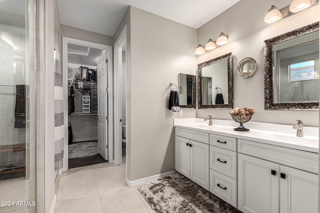 bathroom with vanity, tile patterned floors, and a tile shower