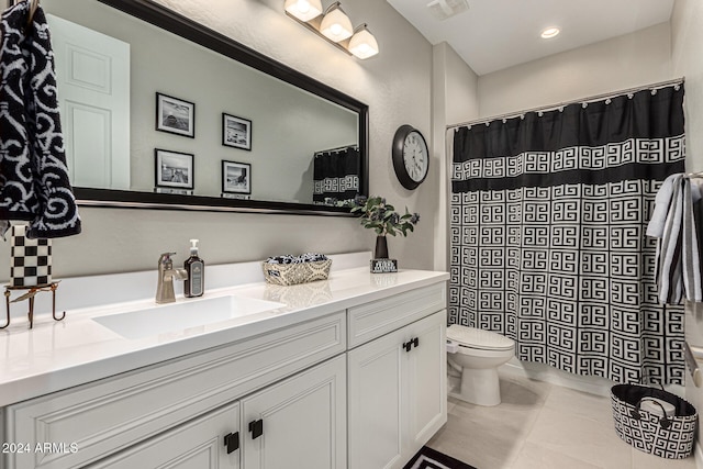 bathroom featuring tile patterned floors, vanity, and toilet