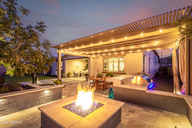 patio terrace at dusk with an outdoor fire pit