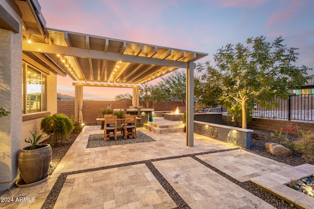 patio terrace at dusk with a pergola