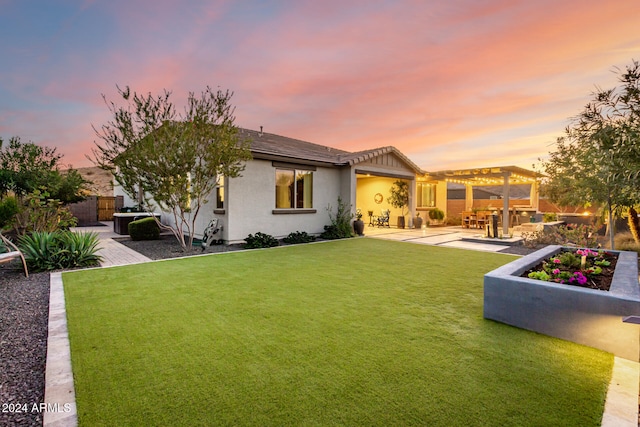 back house at dusk featuring a patio, a pergola, and a lawn