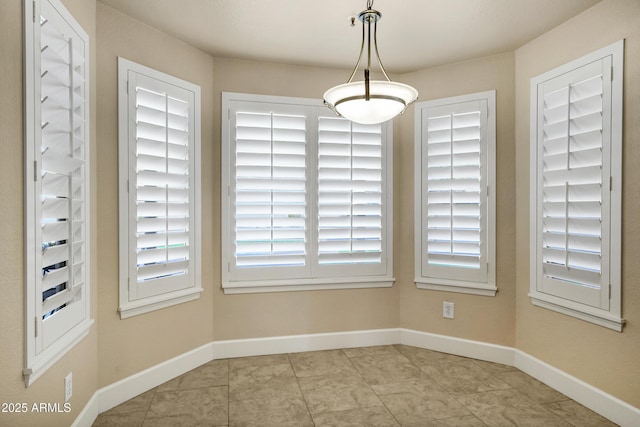 unfurnished dining area with light tile patterned flooring