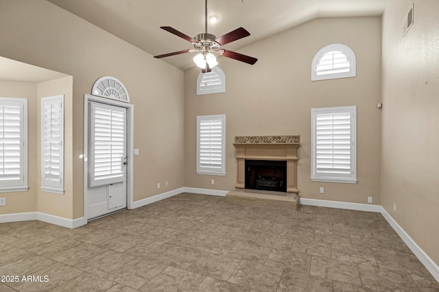 unfurnished living room with high vaulted ceiling and ceiling fan