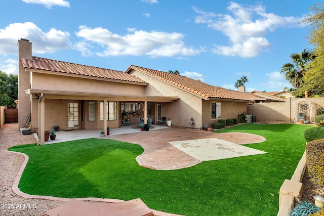 back of house with a patio, central AC unit, and a lawn