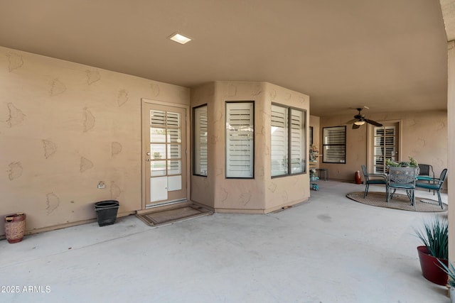 property entrance with ceiling fan and a patio