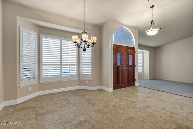 foyer with plenty of natural light and an inviting chandelier